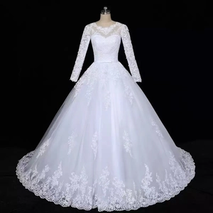 Detailed view of white lace long sleeves and delicate floral embroidery on bridal gown