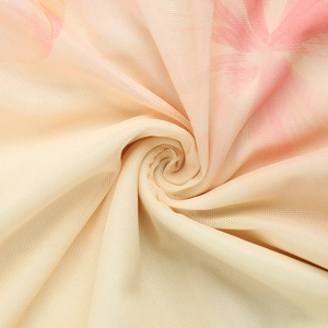 Detailed macro view of lightweight off-white mesh fabric with pink floral patterns