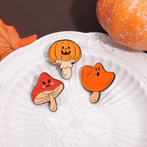 Halloween mushroom enamel pin set featuring pumpkin heads and spooky faces on a plate
