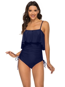 Detail of navy blue one-piece swimsuit featuring ruffled bust and ruched side drawstrings