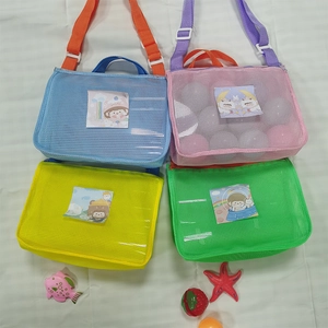 Flat lay of four colorful mesh beach bags for kids with adjustable straps and cartoon inserts