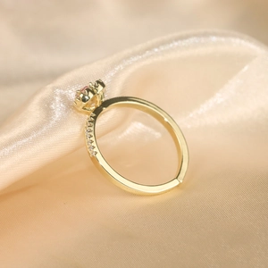 Close-up of pink heart gemstone ring with side diamonds and adjustable golden band
