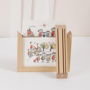 Close-up of magnetic wooden frame with natural finish for stacking children artwork