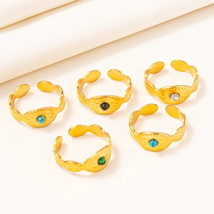Detail of five 304 stainless steel open rings with hammered texture and colorful gemstones
