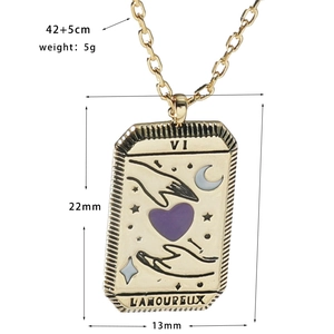 Detail view of gold Tarot The Lovers pendant with purple heart and enamel finish