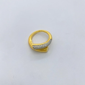 Modern 18k gold plated criss-cross ring with pavé zircons on a white background