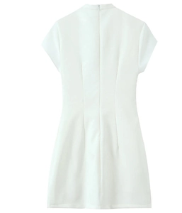Detail of white mini dress featuring high neck, short sleeves and hidden back zipper