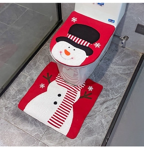 Detail of red Christmas snowman toilet seat cover and matching bathroom floor mat set