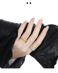 Detailed close-up of S925 sterling silver feather ring and minimalist gold band on hand