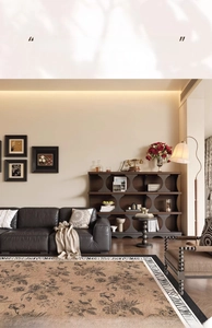 Detailed view of a vintage floral area rug with brown and beige tones in a retro living room
