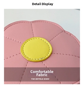 Detailed macro view of pink sunflower bag with yellow center and pebbled leather texture