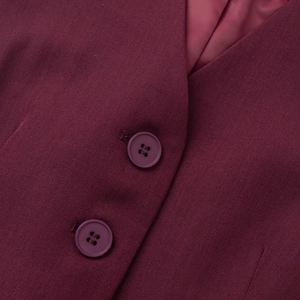 Close-up of burgundy twill vest fabric showing fine texture and resin buttons