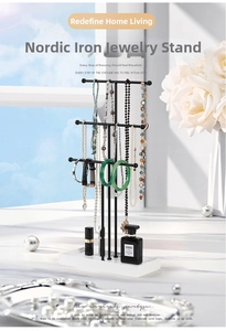 Three-tier black matte metal jewelry stand with a white rectangular tray base for storage