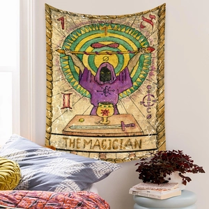 Detail of The Magician tarot tapestry hanging on a white wall in a cozy bedroom setting