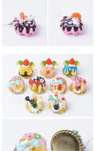 Detail of PVC cream waffle and cake pendants with realistic fruits and pink lanyards