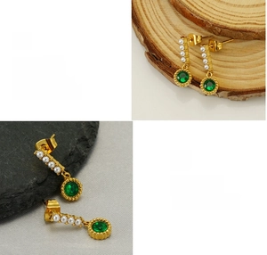 Detail of vintage gold earrings with emerald green gemstone and white teardrop pearls