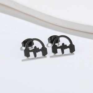 Detail view of black stainless steel stud earrings featuring headphone and heartbeat design