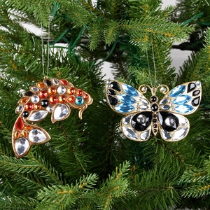Christmas tree ornaments featuring gold iron fish and butterfly pendants with colorful rhinestones