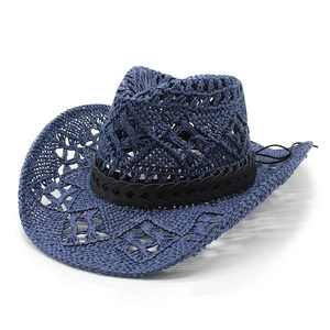 Detail of navy blue woven denim straw hat featuring openwork crochet and black band