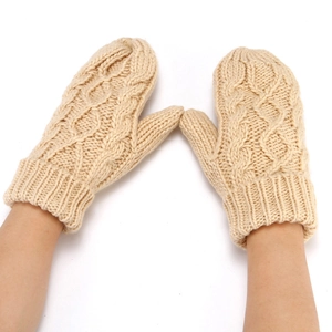 Detail of beige cable knit mittens for women showing thick texture and soft material