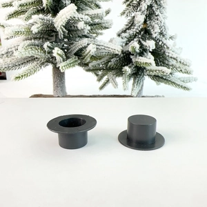 Detailed view of two mini black plastic top hats for DIY Christmas craft decoration