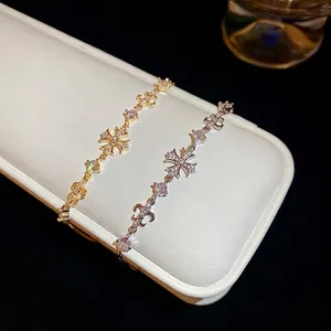 Elegant gold and silver adjustable cross bracelets with fleur-de-lis and zircon inlays