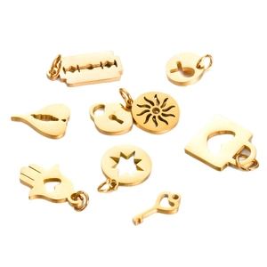 Golden polished stainless steel charms set with sun, star, and hamsa shapes on white background