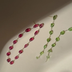 Long beaded tassel earrings with pink strawberry quartz and green beads on gold chains