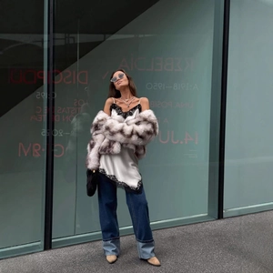 Short faux fur leopard print coat styled with lace camisole and cuffed denim jeans