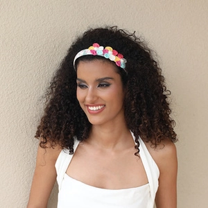 Detailed view of colorful fabric flower headband with pink and blue floral elements
