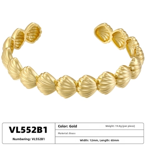 Detail view of golden shell textured adjustable brass bracelet in ocean style design