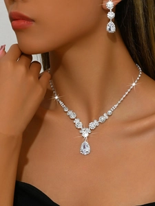 Close-up of sparkling pear-shaped rhinestones on bridal necklace and earrings set