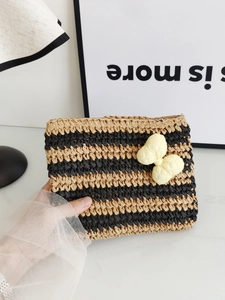 Handcrafted striped straw envelope clutch with a yellow bow and chic beige pattern