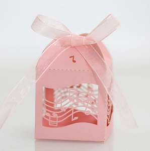 Boîte à dragées rose découpée au laser avec notes de musique et ruban en satin