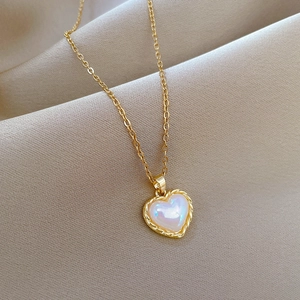 Elegant gold titanium steel heart necklace with white mother of pearl inlay on silk fabric
