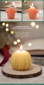Detail of knitted sweater and sphere textured scented candles for Christmas decor