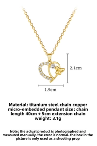 Macro detail of gold heart butterfly pendant with micro-set zircon and 45cm chain length