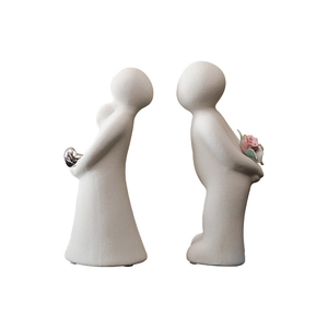 Abstract ceramic couple figurines with matte finish and pink rose detail for home decor
