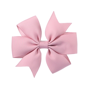 Detailed view of pink grosgrain ribbon bow with clear ribbed texture and swallowtail edge