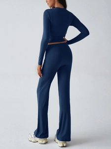 Back view of a navy blue Y2K slim-fit cropped top and matching flared pants set