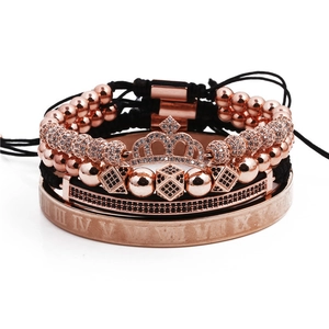 Detailed stack of rose gold roman numeral bangle and crown beaded bracelets