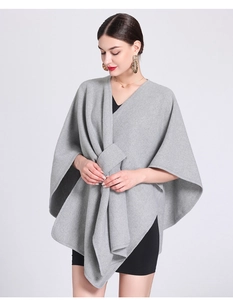 Detail view of a gray knit shawl poncho featuring a stylish front-knot closure for women