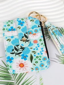Sky blue floral print PU leather coin purse with tassel keychain on a minimalist background