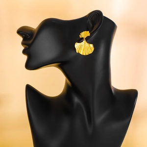 Exaggerated golden ginkgo leaf stud earrings with detailed matte metallic texture