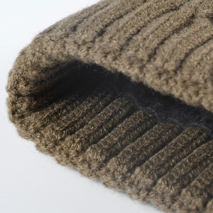 Winter jacquard knit beanie with warm fleece lining and thick ribbed texture in dark olive