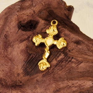 Polished gold 304 stainless steel heart cross pendant displayed on a dark wood background