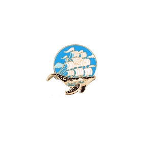 Enamel whale brooch with sailboat and starry sky pattern on a white background