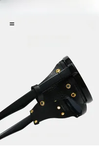 Detail of vintage round sunglasses with black leather side shields and gold metal rivets