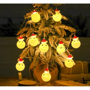 Close-up of snowman LED string lights with warm glow on snow-covered decorative tree