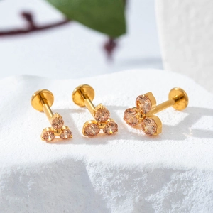 F136 titanium gold labret stud with three champagne zircon stones in a floral design